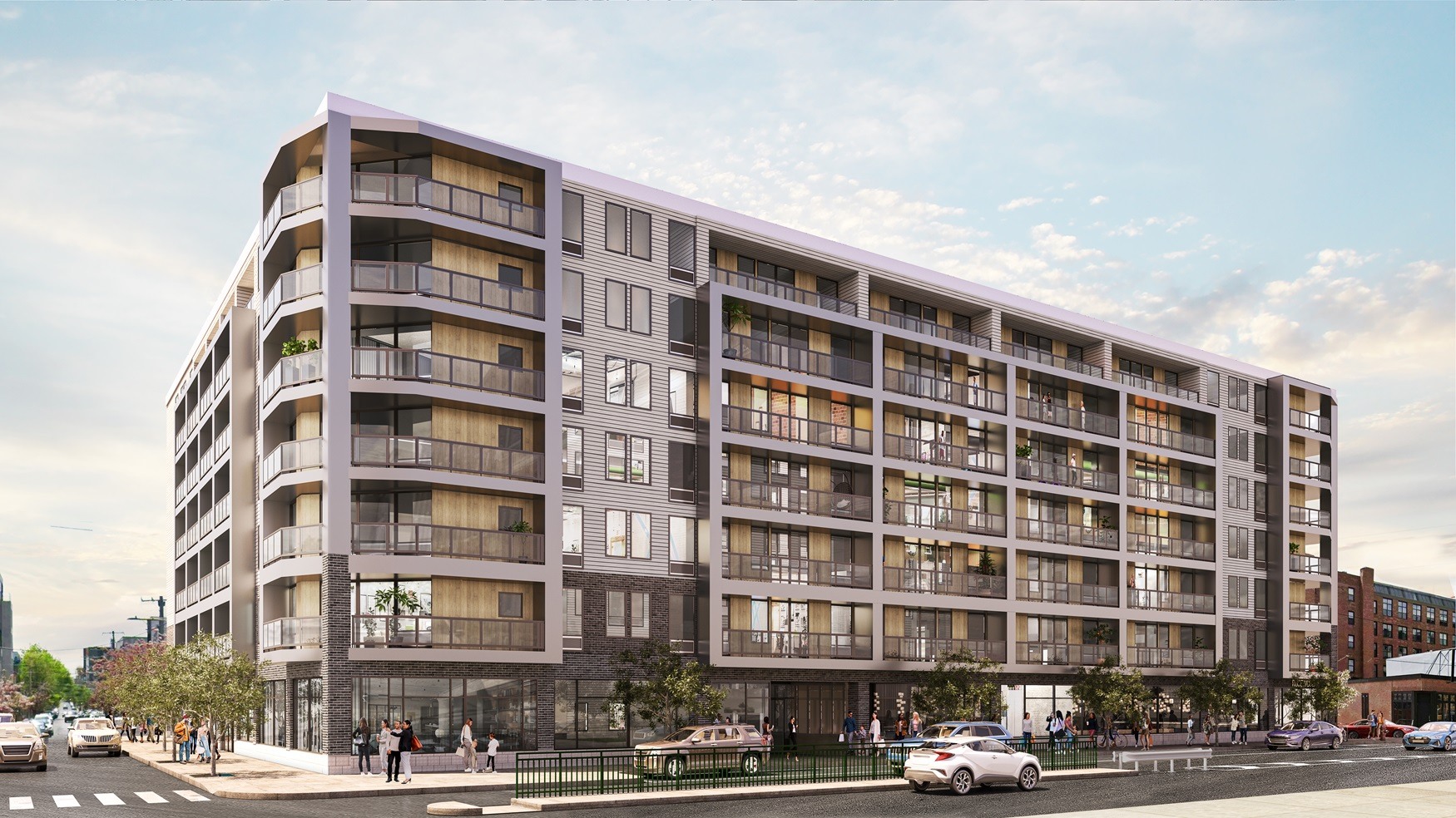 A large, modern apartment building with balconies and multiple stories.
